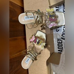 They’re Steve Madden heels, brand new, with cute colorful butterflies on them